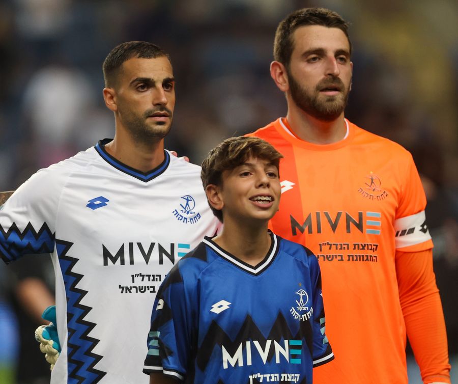 Avishai Cohen (Hapoel Petah Tikva) Three players standing together, possibly during a break in play.