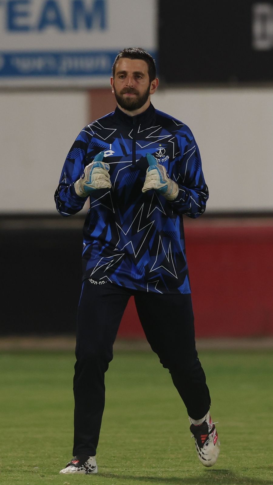 Omer Katz (Hapoel Petah Tikva) is standing with hands clasped in front of him