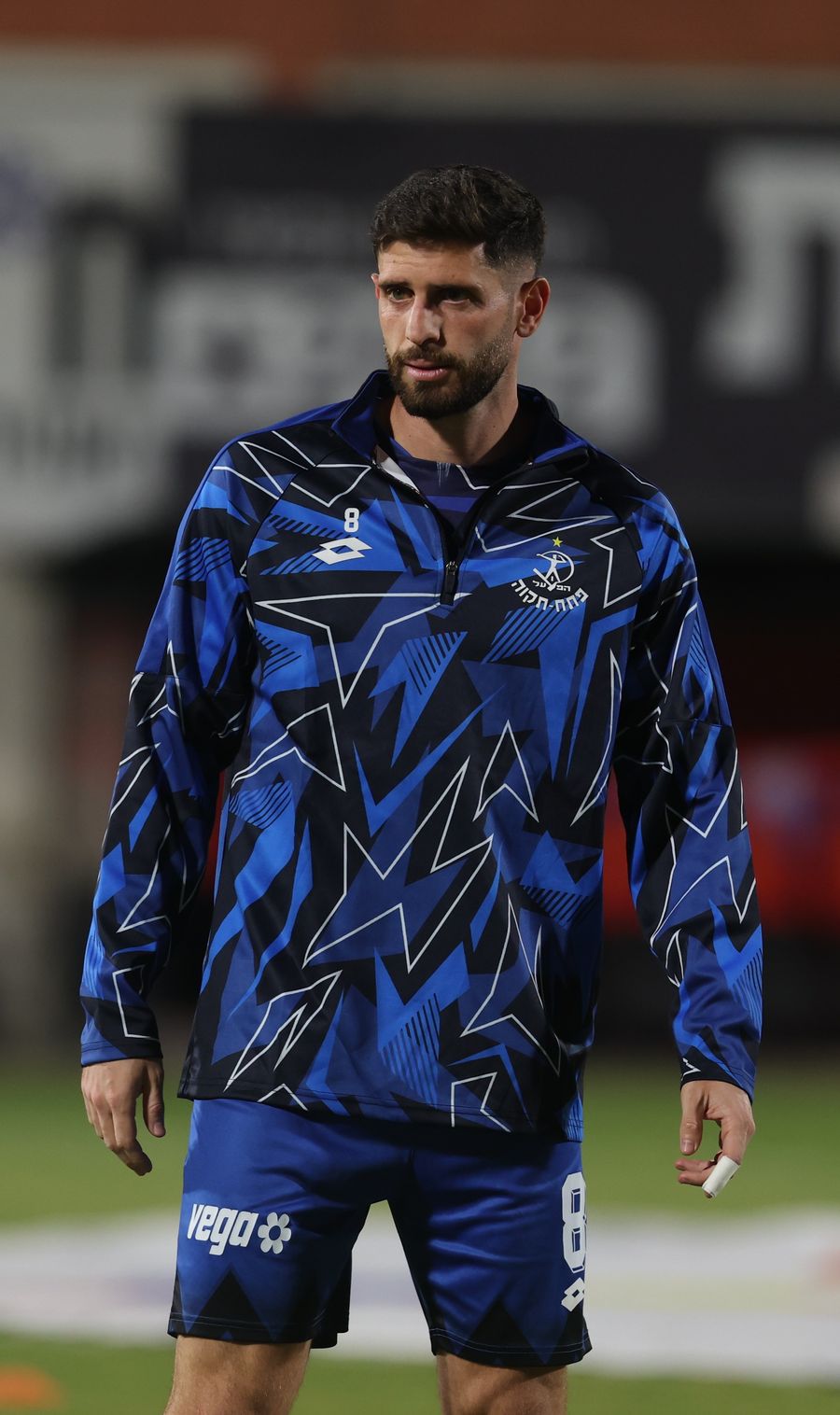 Tomer Altman (#8, Hapoel Petah Tikva) is standing on the field, not in immediate action with the ball