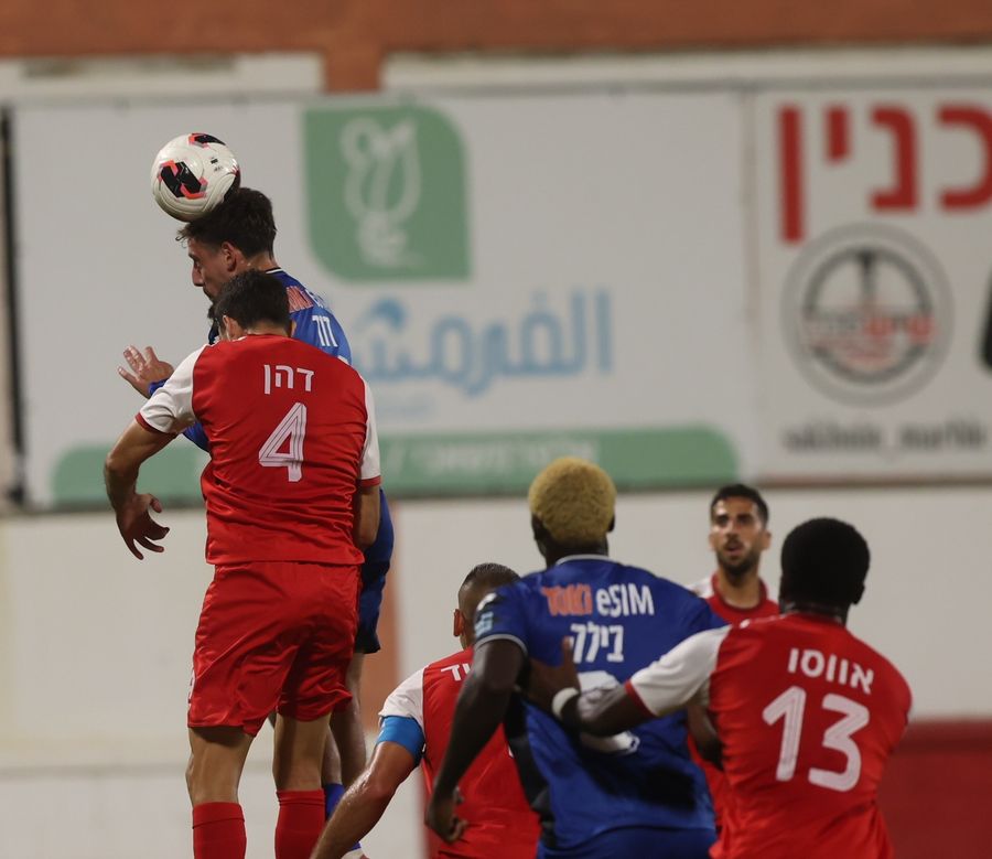 A Bnei Sakhnin player competes for an aerial ball