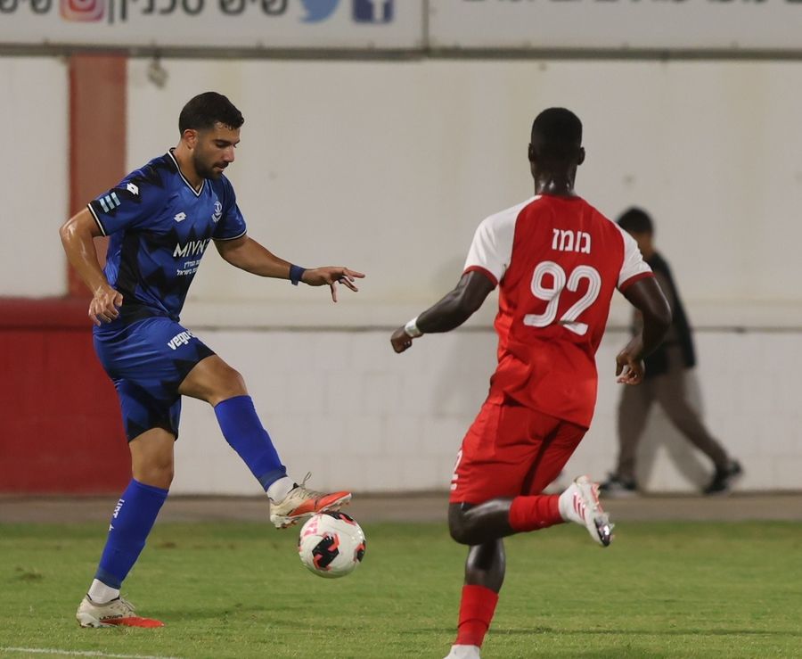 Roy Levy (Hapoel Petah Tikva) strikes the ball from outside the box