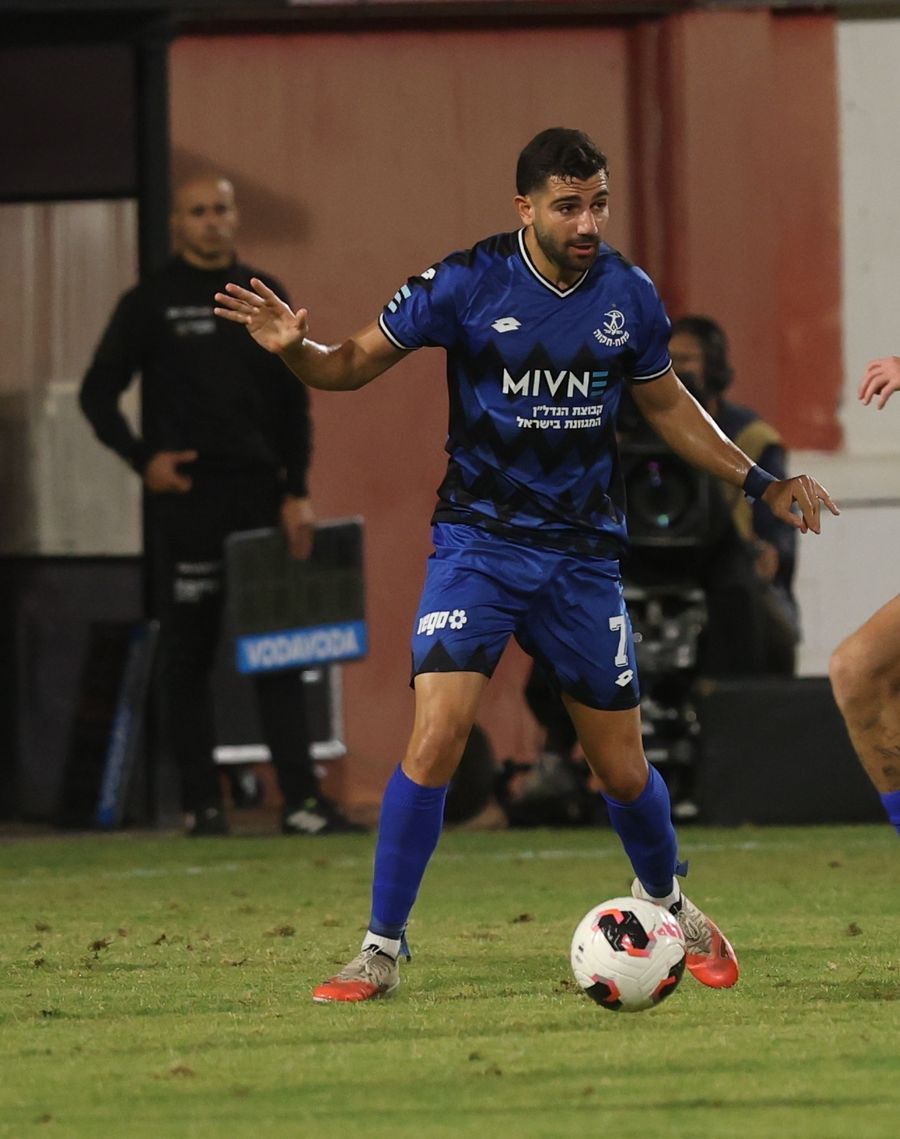 Roy Levy (#7, Hapoel Petah Tikva) strikes the ball from outside the box