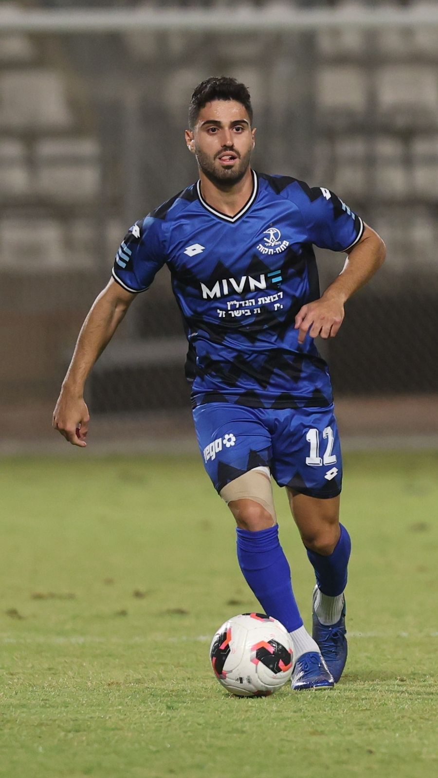 Stav Israeli (#12, Hapoel Petah Tikva) controls the ball with his right foot
