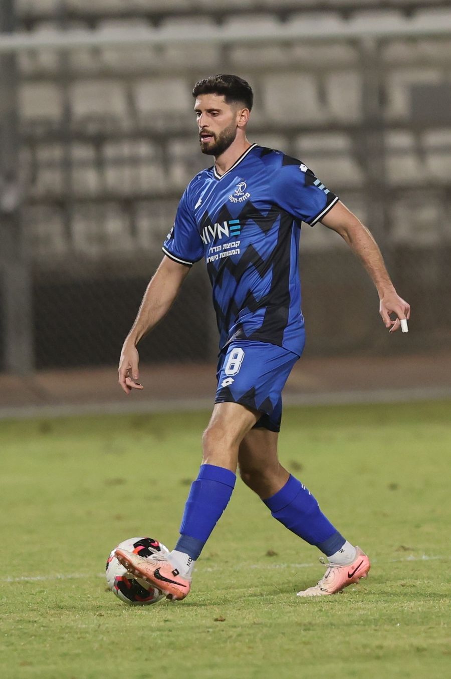 Tomer Altman (#8, Hapoel Petah Tikva) strikes the ball with his right foot