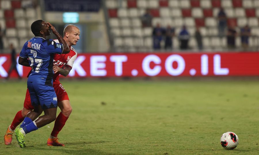 Modestas Vorobjovas (#8, Bnei Sakhnin) defends against an opponent