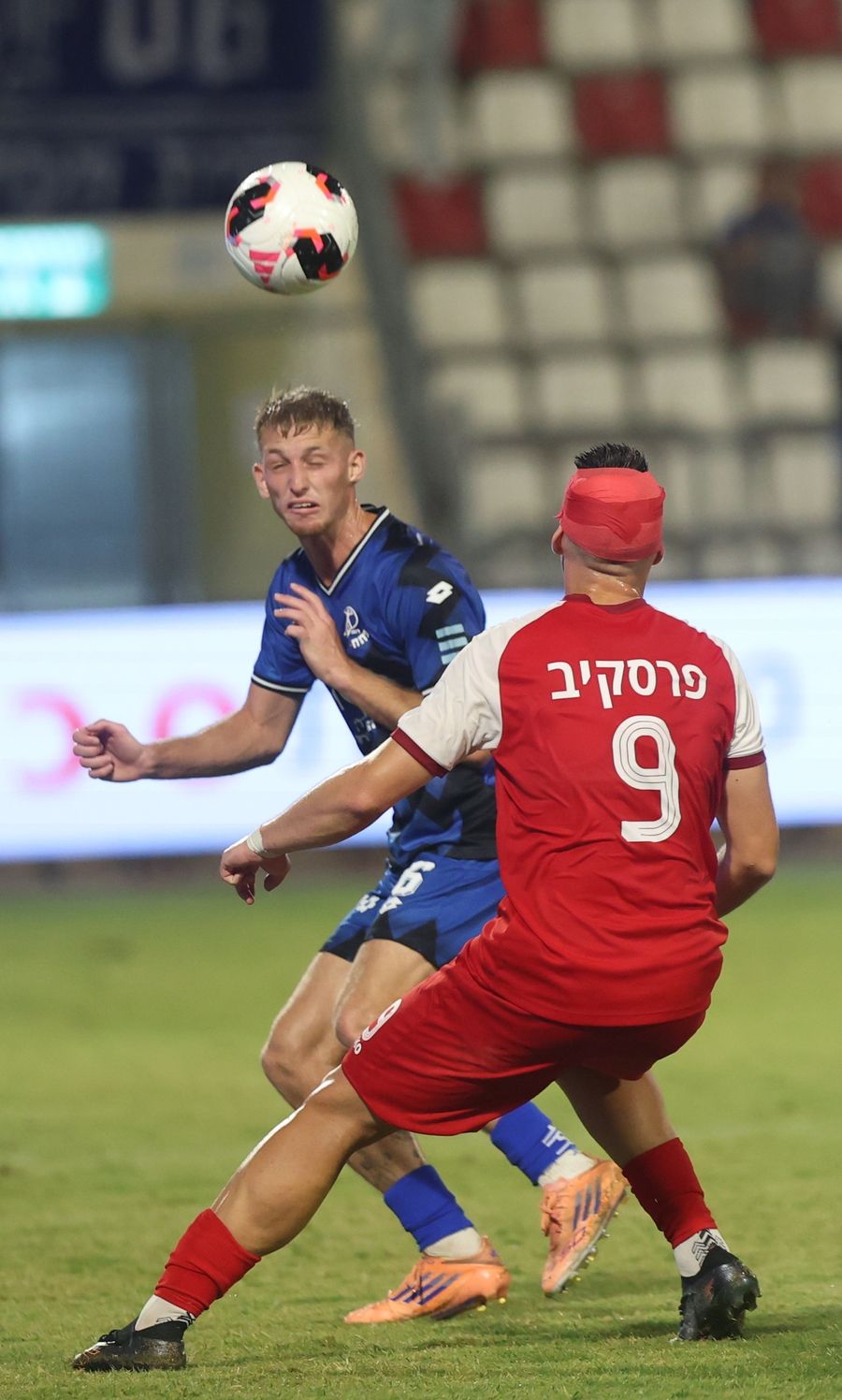 A Bnei Sakhnin player competes for an aerial ball