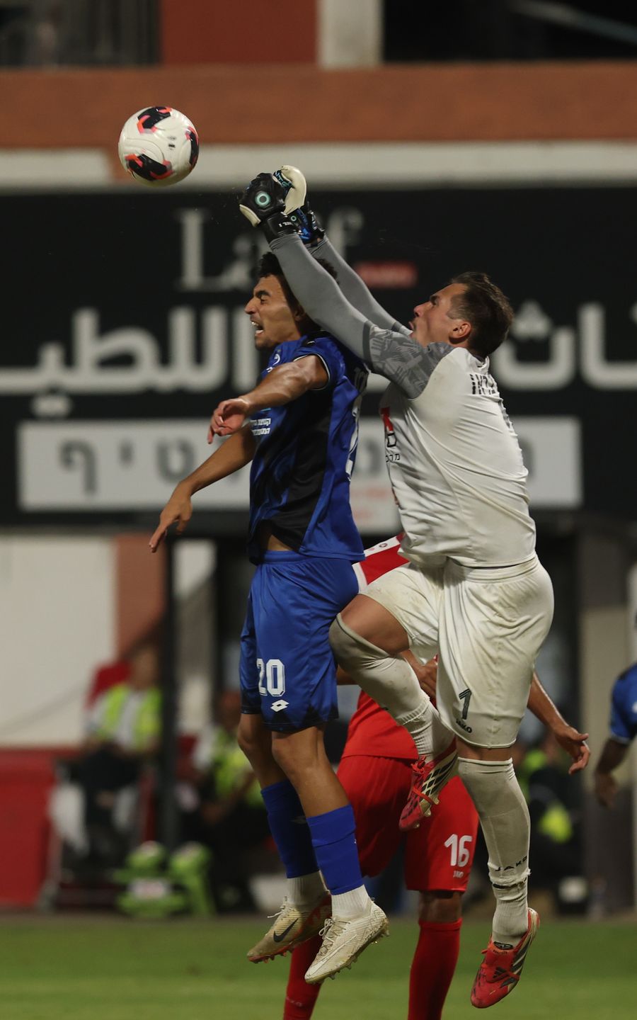 Or Israelov (#20, Hapoel Petah Tikva) jumps to head the ball