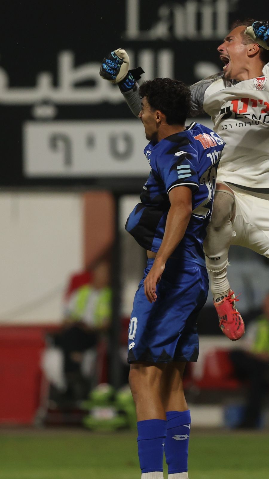 Raul Balbarau (Bnei Sakhnin) jumps to head the ball during a match
