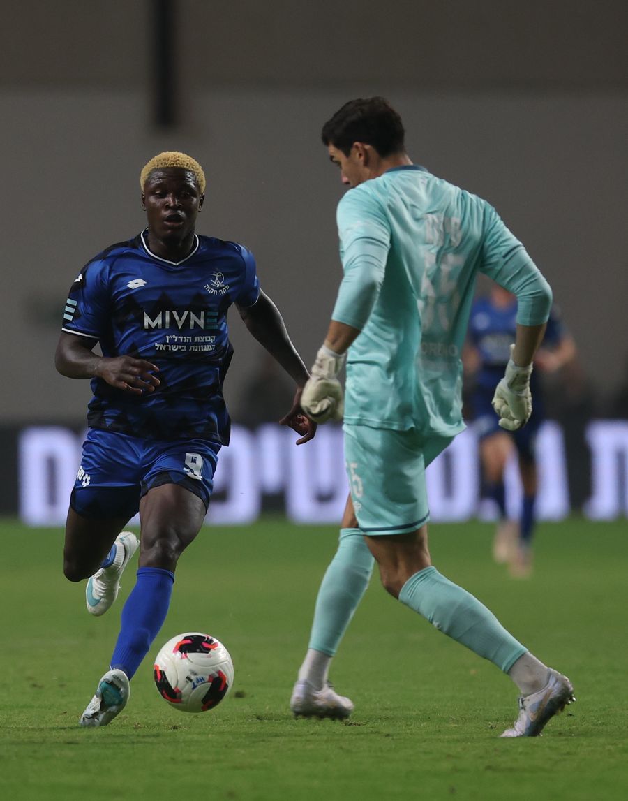 Yves Erick Bile (Hapoel Petah Tikva) strikes the ball with his right foot