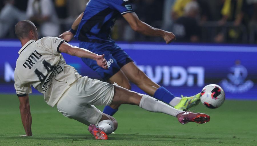 A Hapoel Petah Tikva player strikes the ball with his right foot