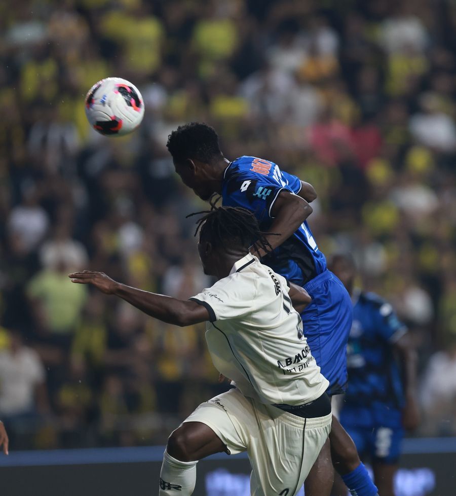 A Hapoel Petah Tikva player competes for an aerial ball