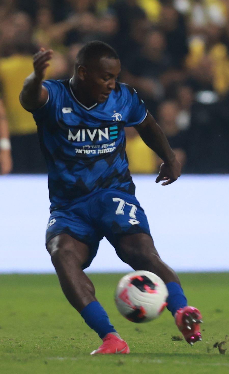 Clé (Hapoel Petah Tikva) strikes the ball with his right foot
