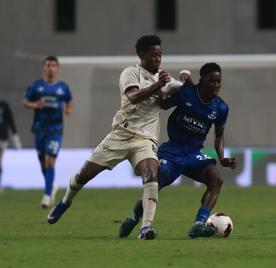 Karim Kimvuidi (Hapoel Petah Tikva) challenges for the ball