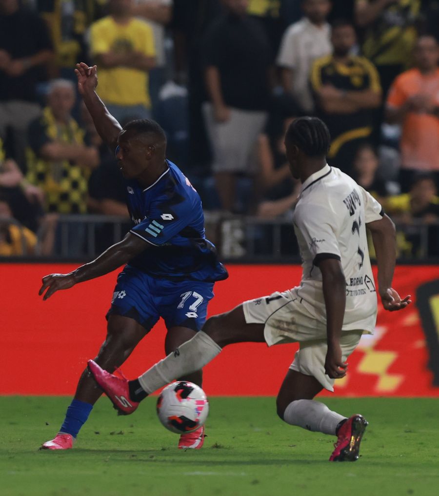 Clé (Hapoel Petah Tikva) strikes the ball with his right foot