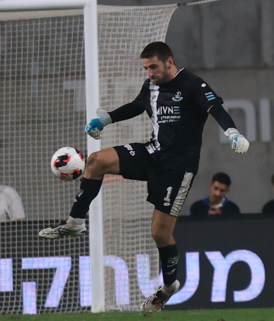 Omer Katz (Hapoel Petah Tikva) strikes the ball with his right foot