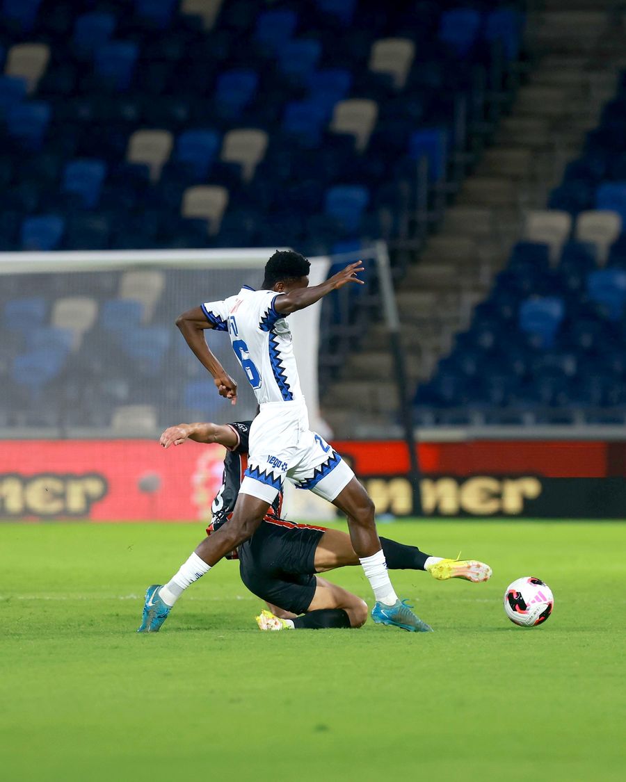 A footballer defends the ball