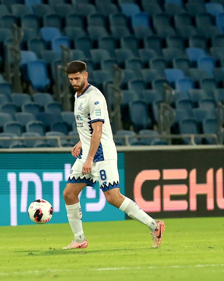 Tomer Altman (#8, Hapoel Petah Tikva) strikes the ball with his right foot