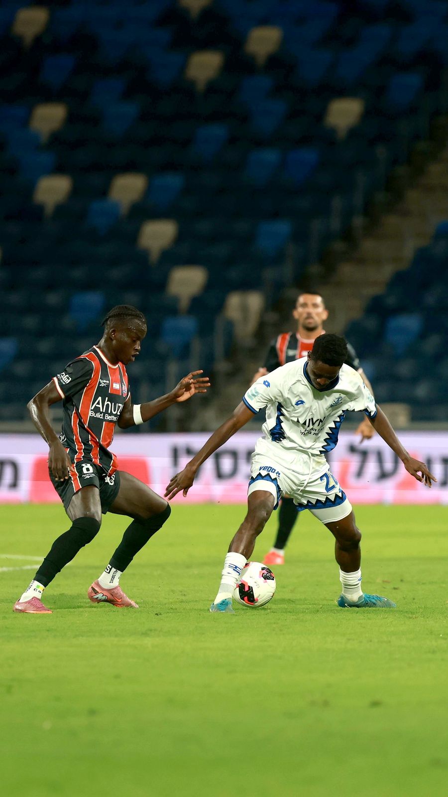 A Hapoel Petah Tikva player strikes the ball with his right foot