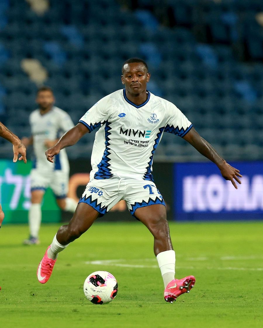 Clé (Hapoel Petah Tikva) strikes the ball from outside the box