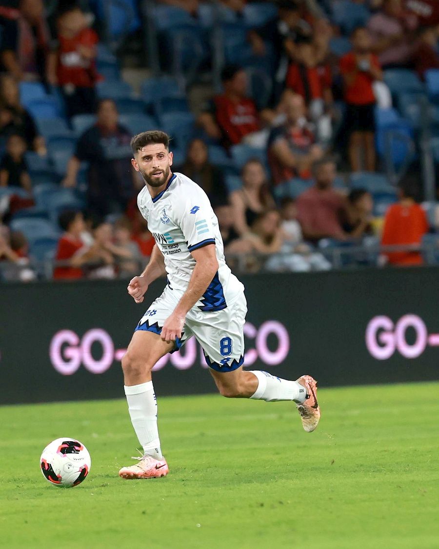 Tomer Altman (#8, Hapoel Petah Tikva) strikes the ball with his right foot
