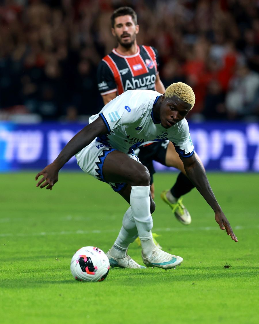 Yves Erick Bile (Hapoel Petah Tikva) strikes the ball with his right foot