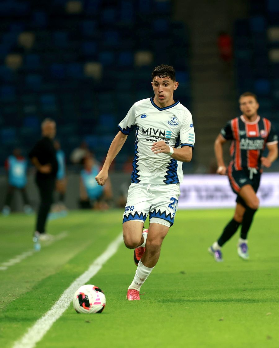 A Hapoel Petah Tikva player runs with the ball