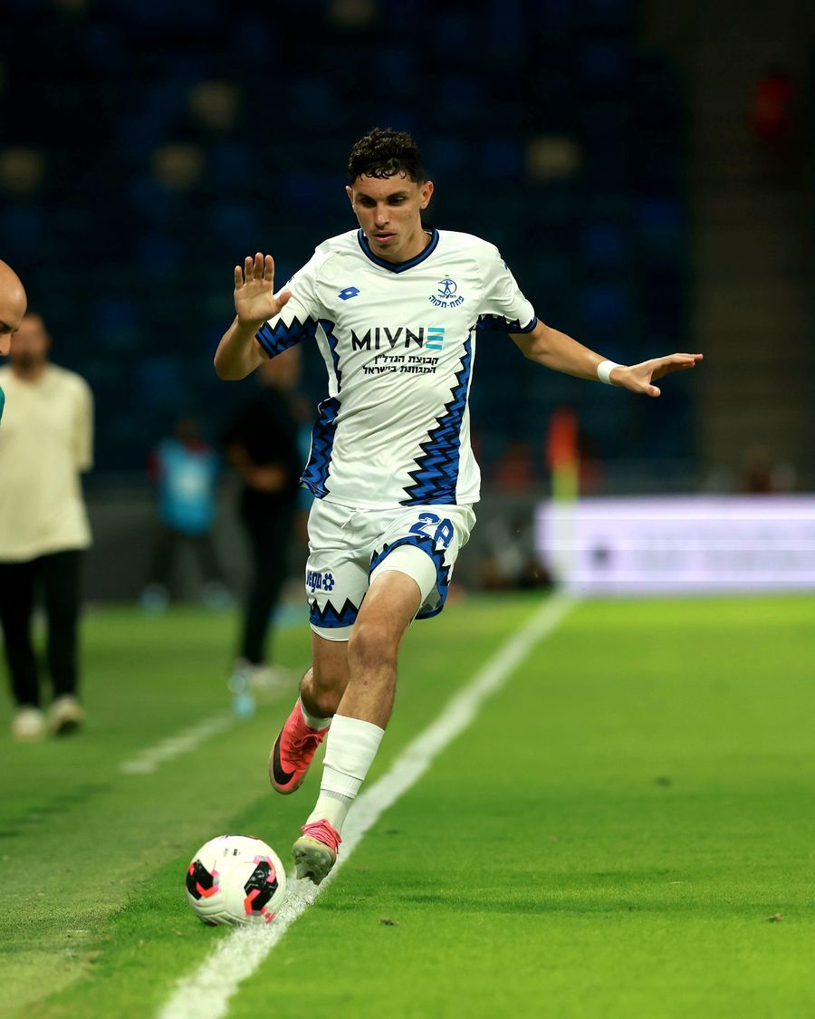 A Hapoel Petah Tikva player strikes the ball with his right foot