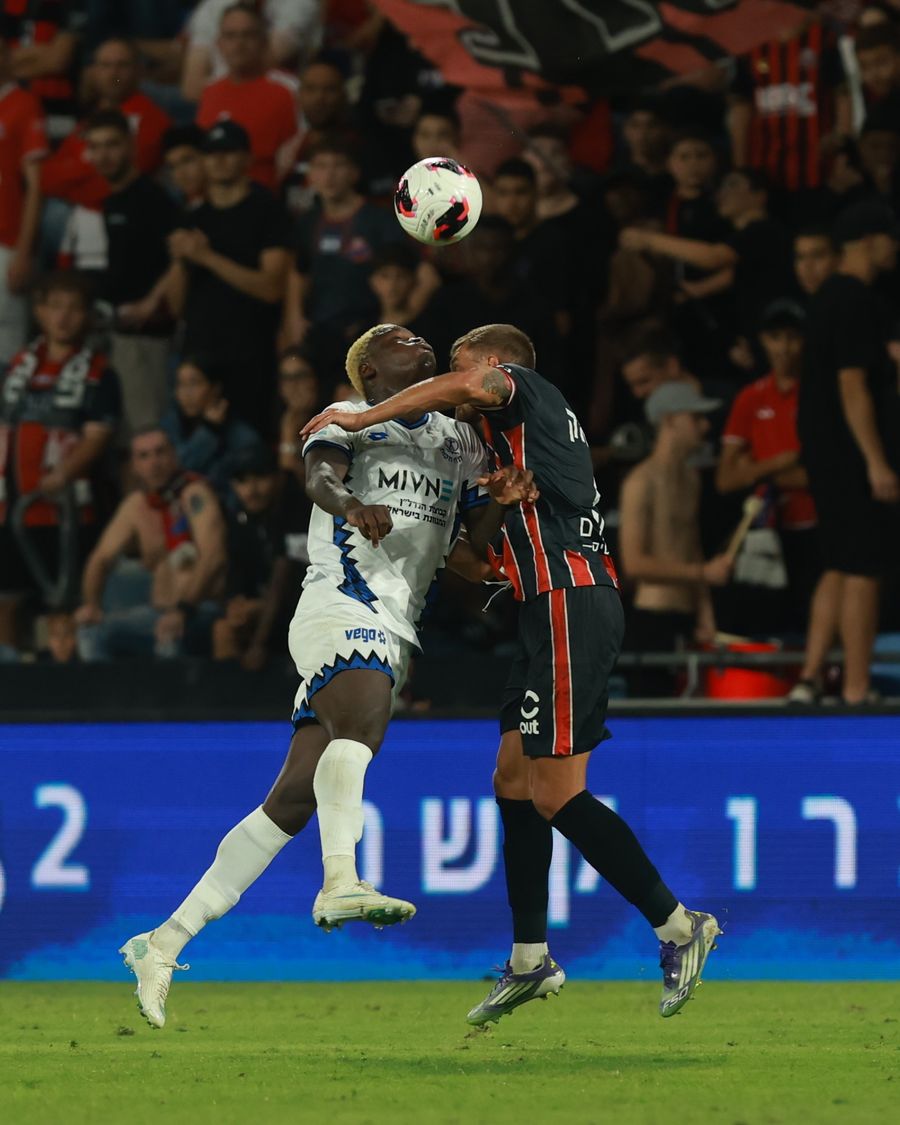 A Hapoel Petah Tikva player competes for an aerial ball