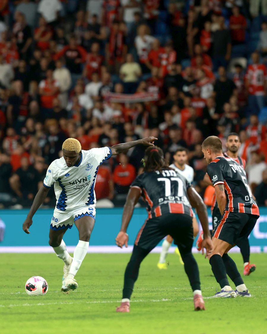 A Hapoel Petah Tikva player strikes the ball with his right foot
